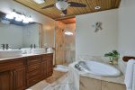 Master bathroom with tub and shower